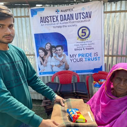 An Austex volunteer distributing winter blankets to an elderly resident